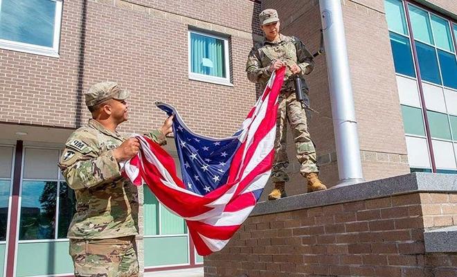 Military students raising a flag
